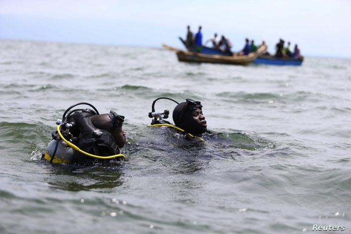 Members of the Uganda Police Marine Unit participate in a rescue operation after a boat carrying mostly Congolese refugees capsized in Lake Albert near Ntoroko