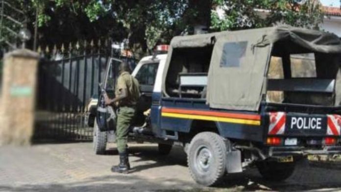 An-armed-Kenya-police-officer-steps-out-of-a-police-car._copy_1200x676