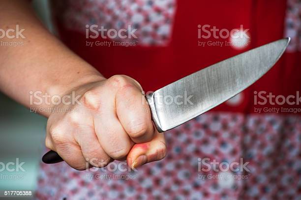 Woman hand holding big knife. Aggressive woman.