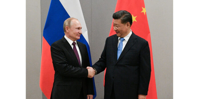 FILE PHOTO: Russian President Putin meets with Chinese President Xi during their meeting on the sideline of the BRICS summit in Brasilia
