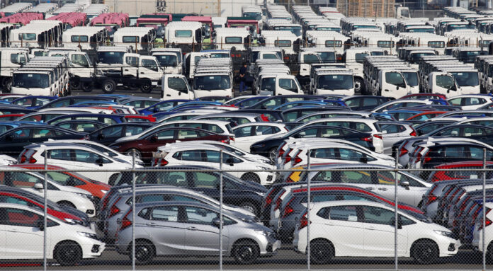 Newly manufactured cars await export at port in Yokohama