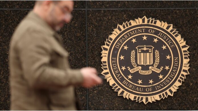 A-person-passes-by-the-FBI-seal-on-the-wall-of-the-FBI-headquarters-in-Washington-U.S.-February-3-2025.-ReutersKevin-Lamarque
